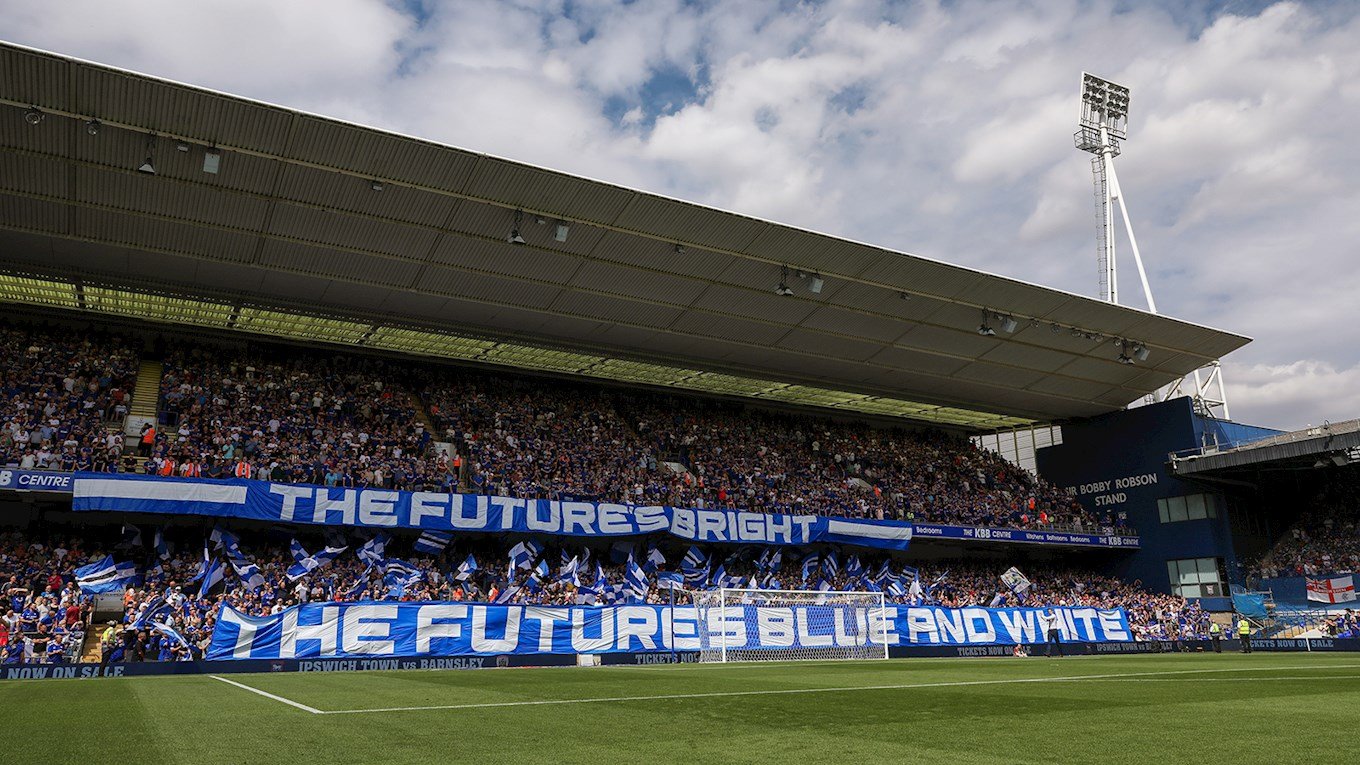 Ipswich Town supporters filling Portman Road stadium with blue and white banners